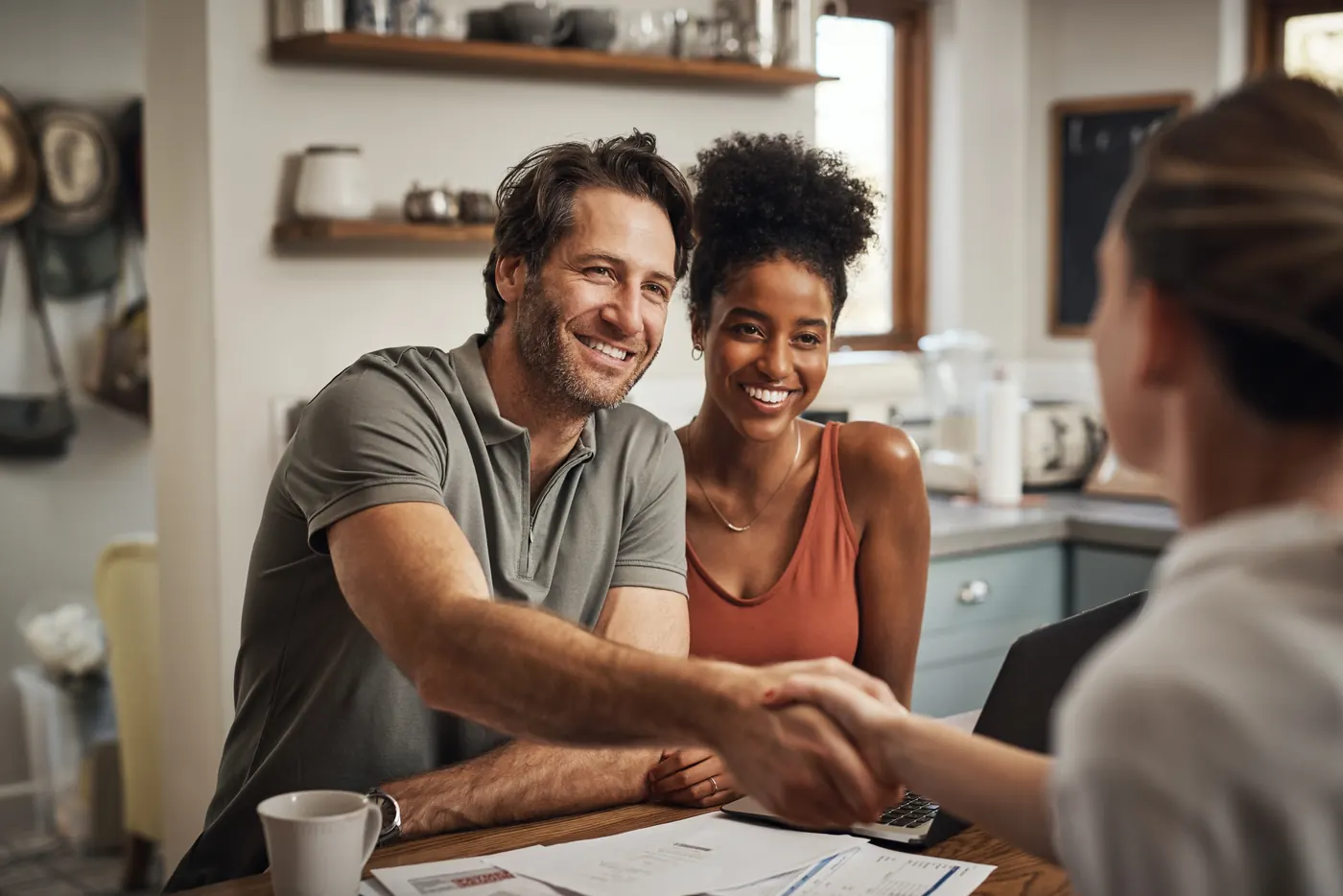 An advisor going through loan numbers with a couple at their kitchen table