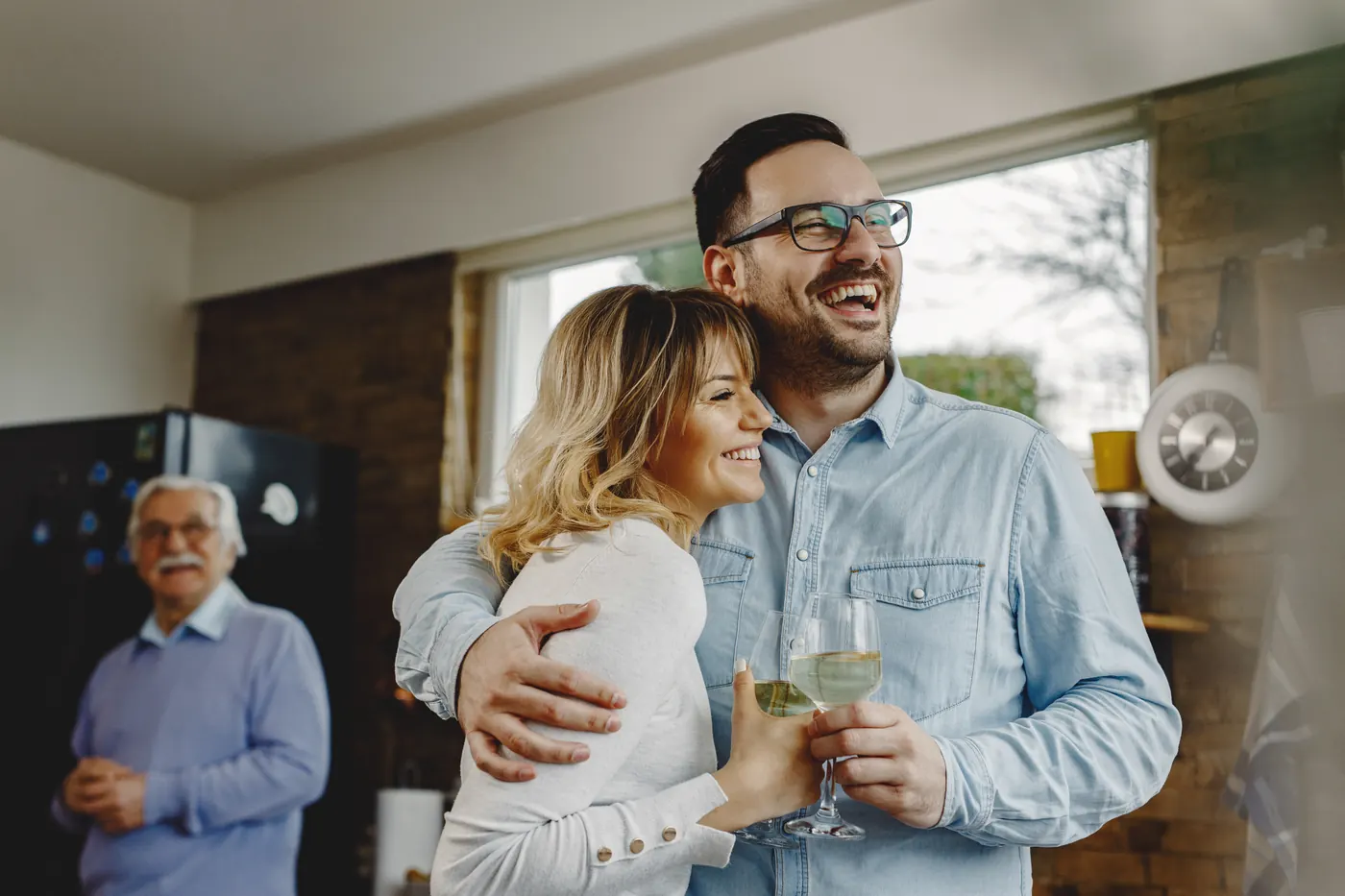 A couple relaxing together in their kitchen at home